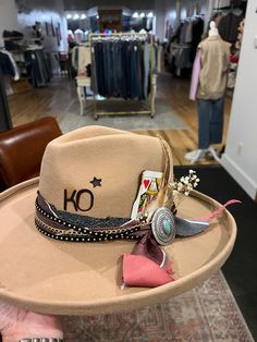 Can't make it to a Hat Bar pop-up or into our store to build a custom hat at our Hat Bar? No problem! Join us for a 1 hour session to create the hat you've been dreaming of. If you'd like to mail me items you'd like included in your custom hat build please mail them to me at 141 S Main Street, Stoddard, WI 54658 at least a week prior to your virtual session. You are responsible for shipping items and your finished hat to you. Included: 1 hour with stylist over FaceTime, all materials and brandin Embellished Cowgirl Hat, Make Your Own Cowgirl Hat, Custom Hat Ideas For Women, Hat Bar Display, Hat Bar Accessories, Painted Cowboy Hats Diy, How To Make A Hat Band, Diy Hat Bar Party, Western Hats For Women Boho