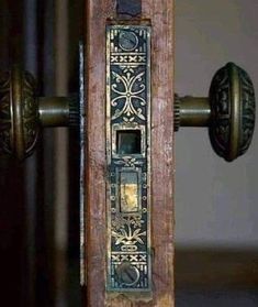 an old door handle with a decorative design on it's front and back side