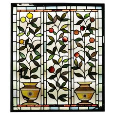 a stained glass window with vases and fruit on it