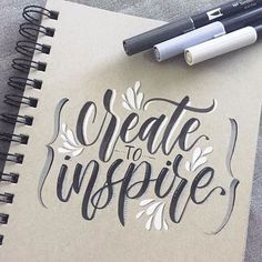 a notepad with the words create to inspire written on it next to a pen