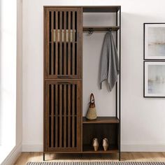 an entryway with a coat rack, hat and shoes on the floor next to a potted plant