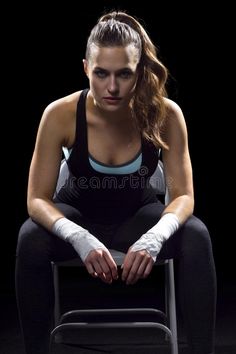 a woman sitting in a chair with bandages on her hands royalty image - free stock photo