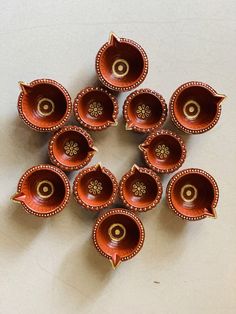 a group of small brown bowls sitting on top of a table