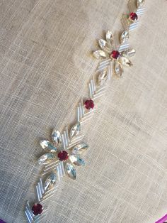 a close up of a piece of cloth with beads and jewels on it's side