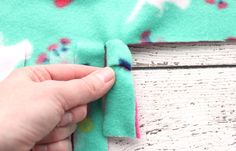 someone is sewing something on the side of a piece of fabric that has been sewn together