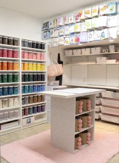 a craft room filled with lots of different types of thread and spools on shelves