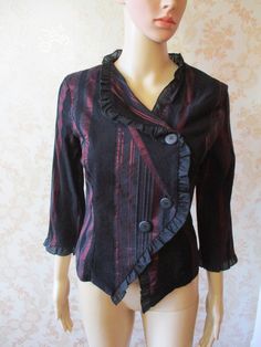 "Vintage half sleeved jacket \\ top in black with an iridescent red stripe.  It has an asymetric collar with a black ruffle down the front and cuffs. Three large buttons to close. Pit to pit;  18\" Length;  20\" Inside sleeve;  12\" Made by PATRICIA BREAL" Gothic Ruffled Blouse For Spring, Spring Gothic Blouse With Ruffles, Fitted Formal Fall Blouse, Fitted Formal Blouse For Fall, Fitted Blouse For Formal Occasions In Fall, Red Fitted Outerwear For Alternative Fashion, Fitted Red Outerwear For Alternative Fashion, Gothic Party Tops With Buttons, Elegant Striped Fall Blouse