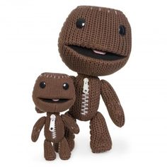 a knitted toy with a small stuffed animal on it's lap, both facing each other