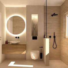 a bathroom with a sink, toilet and shower in it's center wall is illuminated by round mirrors