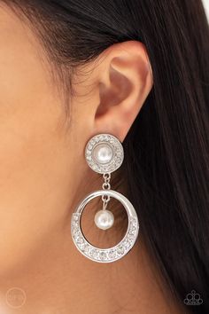 a close up of a person wearing earrings with pearls on the bottom and an ear chain