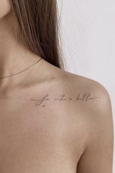 the back of a woman's shoulder with writing on it