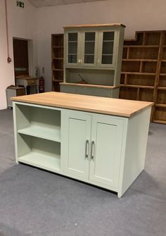 an empty room with cabinets and shelves in it