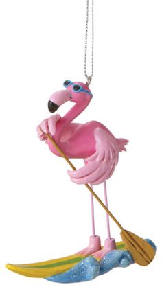 a pink flamingo on a surfboard ornament