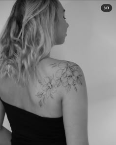 a woman with a flower tattoo on her back