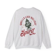 Spread some holiday cheer (and a pine-fresh scent!) with this hilarious retro Christmas sweatshirt! Featuring the playful phrase "Smells Like Holiday Spirit" on the back and a cute pine tree car air freshener graphic, this cozy sweater is perfect for anyone who loves Christmas and a good laugh.   - Unisex sizing. Fits true to size for most. Order up for an oversized fit.   - Soft, comfortable fabric for all-day wear, ideal for cozy movie nights or holiday gatherings   - Funny and festive design with a retro touch and a distressed design   - Direct to garment print (see note)   - "Festive" printed on the front for extra holiday cheer   - Multiple sizes and colors available to match any style   - Makes a hilarious and unique gift for any fun-loving friend or family member Whether you're deco Casual Holiday Sweatshirt With Graphic Print, Casual Graphic Print Sweatshirt For Holiday, Casual Graphic Print Holiday Sweatshirt, Casual Holiday Sweater With Graphic Print, Holiday Cotton Sweatshirt With Graphic Print, Holiday Graphic Print Cotton Sweatshirt, Christmas Graphic Print Relaxed Fit Sweatshirt, Funny Holiday, Sweater For Women