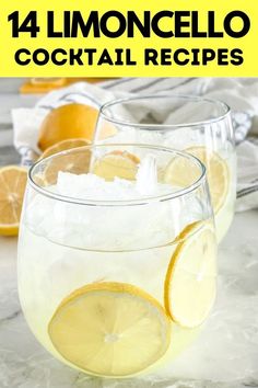 two glasses filled with lemonade and ice sitting on top of a marble countertop