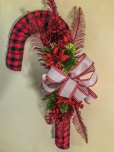 a red and black plaid christmas decoration on a wall