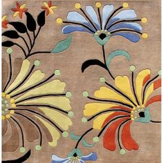 an area rug with flowers on it in various colors and shapes, including blue, yellow, red, green, orange, and black