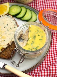 a plate with bread, cucumber and spread on it