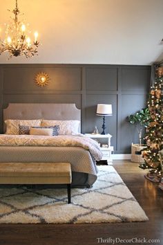 a bedroom decorated for christmas with lights on the headboard and chandelier hanging from the ceiling