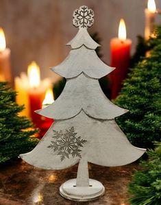 a wooden christmas tree sitting on top of a table