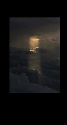 the sun is shining through clouds in the night sky with light coming from behind it