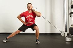 a man is doing squats in front of a barbell machine with one hand on his hip