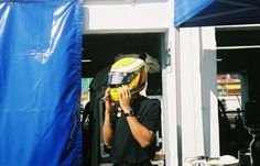 a man talking on his cell phone while wearing a helmet