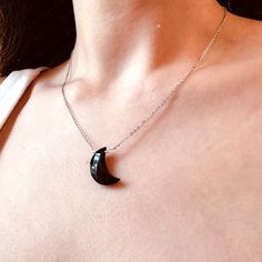 black onyx crescent moon necklace Elegant Black Necklace With Moon Charm, Black Moon Phase Round Pendant Necklace, Elegant Black Crescent Necklace, Black Moon Phase Round Pendant Jewelry, Elegant Black Moon Phase Necklace, Black Half Moon Jewelry With Moon Phase Design, Black Sterling Silver Moon Phase Necklace, Black Half Moon Jewelry With Moon Phase Detail, Minimalist Black Moon Necklace