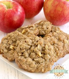 two cookies and three apples on a white plate