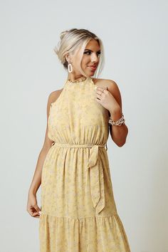 You are sure to feel nothing but happiness when you dress to impress in this beautiful primrose yellow colored maxi featuring lightweight flowy material patterned with a subtle floral print, a high neckline with a halter tie closure, ruffled trim detailing, a cinched waistline with a tie belt, and a relaxed tiered skirt silhouette that cascades into a straight ankle-length hemline! Primrose Yellow, Feel Nothing, Plaid Jacket, Model Fits, Women Clothing Boutique, Tiered Skirt, High Neckline, Tie Belt, Hip Length