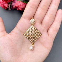 Featuring a pearl pendant set made in 22ct gold. The pendant set weighs 11.37 GMs including 0.76 GMs of hanging pearls. Price Breakup Summary Component Rupees % of Total 22k Gold 51,404 76.7% Stones & Beads 4,420 6.6% Making Charges 9,253 13.8% Taxes (GST) 1,952 3.0% Total 67,030 100.0% View Detailed Price Breakup Gold Kundan Pearl Pendant Necklace, Gold Chandbali Pearl Necklace As Gift, Gold Chandbali Pearl Necklace For Gift, Gold Kundan Chandbali Necklace With Pearl Pendant, Wedding Pearl Pendant Earrings, Gold Pendant Earrings With Stone Work, Gold Pearl Necklace With Stone Work For Formal Occasions, Festive Gold Jewelry Set With Pearl Pendant, Formal Gold Pearl Necklace With Stone Work