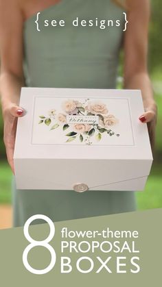 a woman holding a white box with flowers on it and the words 8 flower - theme prop