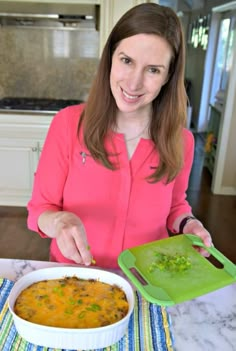 a woman is holding a green tray with food in it