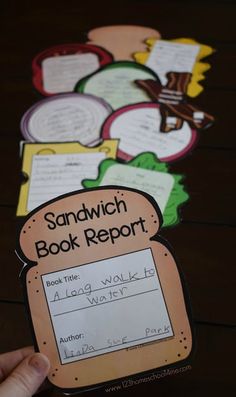 a hand holding up a sandwich book report