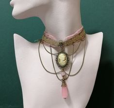 This Victorian inspired elegant romantic choker supplemented with Victorian Ladies cameo pendant, chain and transparent pink chalcedony teardrop are very attractive and posh accents for your special occasions or Gothic wedding.  Can be used as accessory for any kind of dresses - evening or casual, cocktail, sleeveless, long sleeve, bustier style dress or top. Also will look well with any kind of jackets. Choker height----1 inches (2.5 cm) Pendant height---4 inches(10 cm) Necklace length----14,5 Vintage Cameo Choker Necklace, Pink Vintage Choker Jewelry, Elegant Pink Choker As Gift, Elegant Pink Choker For Gift, Elegant Handmade Pink Choker, Vintage Pink Choker Necklace, Cameo Choker, Pink Velvet Ribbon, Yellow Gloves