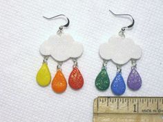 This is a Uniquely Handcrafted pair of Earrings featuring Super Cute Sparkling Rainbow Raindrops & Clouds- featuring a Sparkling dusted Glitter Cloud with Rainbow Colored Sparkling raindrop dangles. Great Fun for Summertime or the Beach :) Completely Handmade Artisan Earrings displaying OUTRAGEOUS Details- Earwires are hypoallergenic. Super FUN- Beautiful Colors Dangle nicely from ears, comfortable weight. - Length = SEE pictures for ruler measurement & DETAILS :) Please SEE my other lis Cute Rainbow Dangle Earrings, Cute Rainbow Jewelry For Pierced Ears, Single Rainbow Earring For Gift, Rainbow Single Earring As Gift, Rainbow Hypoallergenic Earrings As Gift, Whimsical Rainbow Dangle Jewelry, Rainbow Drop Earrings For Pierced Ears, Rainbow Hypoallergenic Dangle Jewelry, Hypoallergenic Rainbow Dangle Jewelry