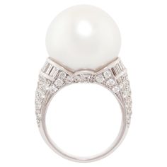 The South Sea pearl and diamond cocktail ring features a voluminous gem quality pearl of 18mm diameter. The pearl is untreated. It displays a fine nacre and its natural color and luster have not been enhanced in any way. The pearl is flanked by custom cut baguette diamonds (0.86 carats) and the elegant design is complete with 1.60 carats of pavé set round diamonds. All diamonds are of top quality (F/G-VVS, color, clarity and cut). The ring is one-of-a-kind. It was handmade in Italy by maestro Gi Cocktail Ring Designs, Pearl Cocktail Ring, Diamond Cocktail Ring, Baguette Diamonds, Diamond Cocktail Rings, Sea Pearl, Bracelet Design, South Sea Pearls, Sea Pearls