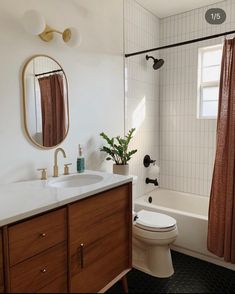 a bathroom with a sink, toilet and bathtub next to a shower curtained window