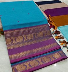 This saree comes with beautiful kanchivaram style gold/copper zari woven borders on chettinad cotton with body woven buttas. Pallu has simple and elegant stripes with buttas. These sarees are a fusion of Chettinad Cottons sarees with Kanchivaram style copper/gold zari woven borders. Running Blouse (5.5 + 0.7 m) Fall and pico - not done Blue Cotton Saree For Diwali, Blue Cotton Saree With Pallu, Blue Cotton Dupatta With Zari Weaving, Blue Cotton Saree With Zari Weaving, Blue Cotton Saree With Printed Border, Purple Cotton Traditional Wear With Cutdana, Cotton Dupatta With Border For Diwali, Blue Cotton Traditional Wear With Printed Border, Purple Cotton Handloom Saree