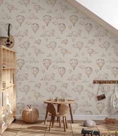 a child's room with hot air balloons on the wall and wooden flooring