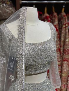 Stonington grey lehenga with frosted crystal embroidery teamed with 3/4 sleeves blouse with crystal embroidery and net dupatta. Fabric: Net Size :38 Ready to Ship! Silver Party Wear Choli For Reception, Semi-stitched Silver Sets For Wedding, Formal Silver Sets With Intricate Embroidery, Formal Organza Lehenga With Mirror Work, Silver Wedding Sets With Resham Embroidery, Elegant Silver Lehenga With Stone Work, Grey Lehenga Blouse Designs, Silver Dupatta For Wedding Party Wear, Silver Party Wear Dupatta For Wedding