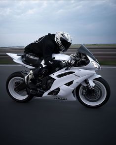 a man riding on the back of a white motorcycle