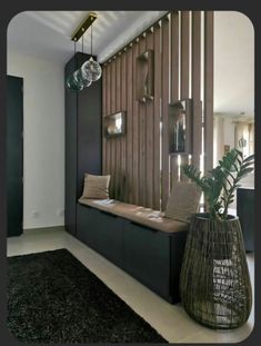 a living room filled with lots of furniture next to a wooden slatted wall