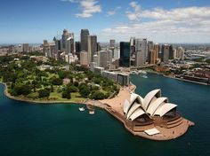 an aerial view of sydney, australia with the opera house in the foreground and city skyline