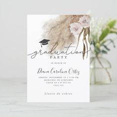 a graduation party card with flowers and feathers