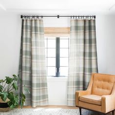 a living room with a chair, window and rug