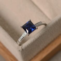 This ring features a 6*6mm princess cut lab sapphire and sterling silver finished with rhodium. Customization is available. It is made by hand, and it will take about 7 days to finish the ring after your payment is completed. Any question, just let me know. :) My shop homepage: https://www.etsy.com/shop/LuoJewelry?ref=l2-shopheader-name Princess Cut Jewelry With Accent Stones, Classic Princess Cut Lab-created Sapphire Ring, Anniversary Sapphire Ring Square Cut, Anniversary Square Cut Sapphire Ring, Princess Cut Solitaire Sapphire Jewelry, Solitaire Sapphire Jewelry With Princess Cut, Elegant Square Cut Sapphire Promise Ring, Elegant Sapphire Square Cut Promise Ring, Square Cut Sapphire Ring For Promise