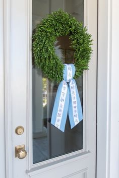 a wreath is hanging on the front door