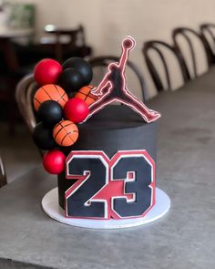 a birthday cake decorated with basketballs and balloons